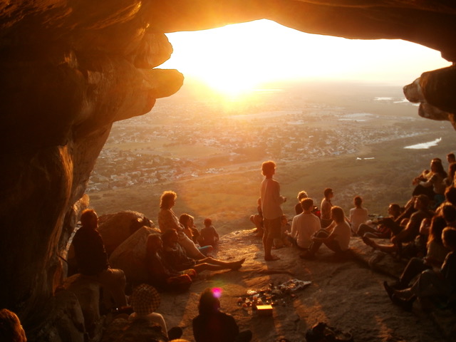 A group of people sitting in a cave