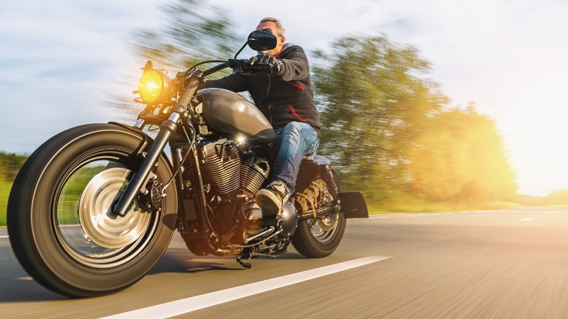 Biker driving with the sun in the background