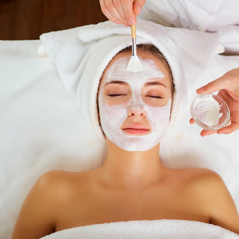 Woman having a white face mask applied